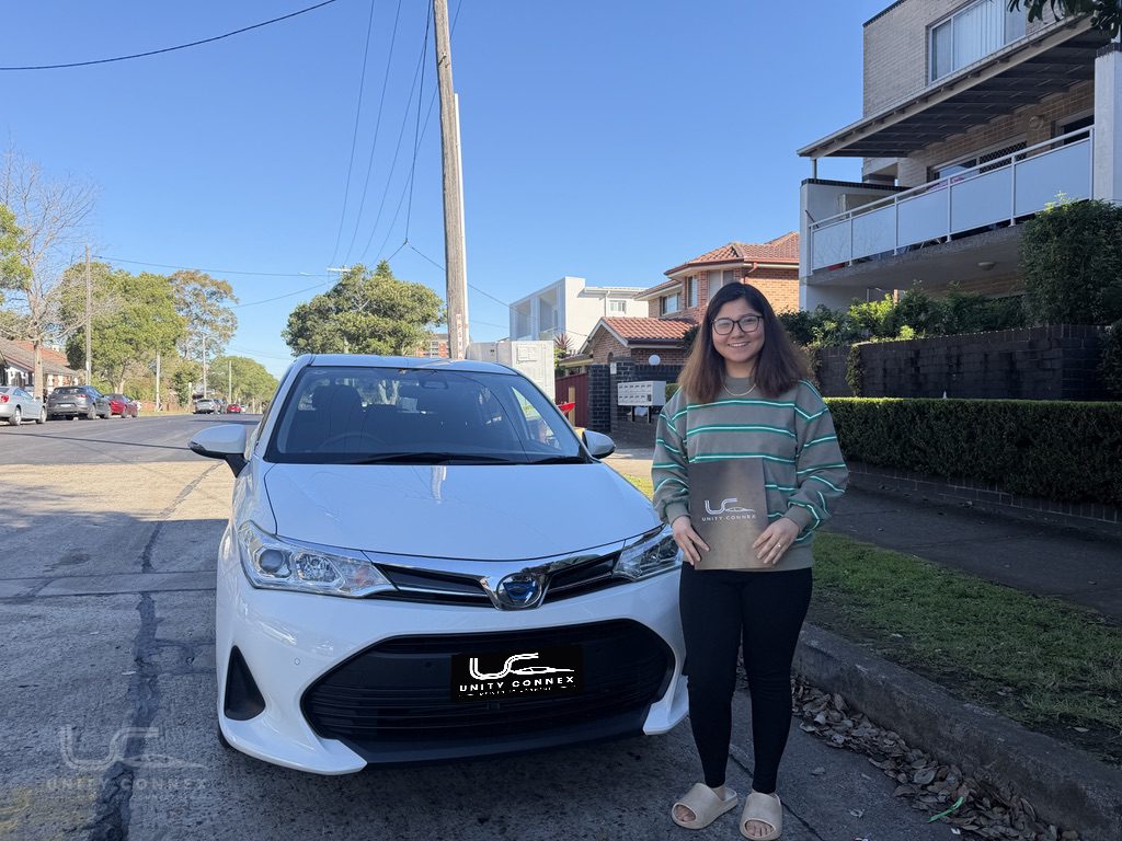 Yangchen celebrating delivery of Toyota Corolla Fielder at Unity Connex — photo 1 of 2